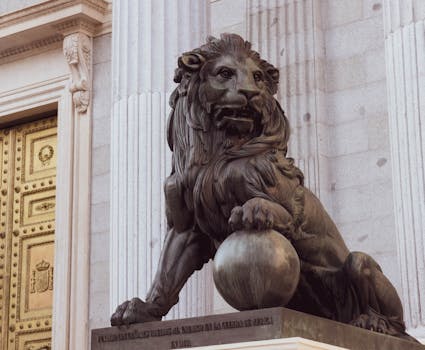 Elegant lion sculpture outside the Congress of Deputies in Madrid, Spain.