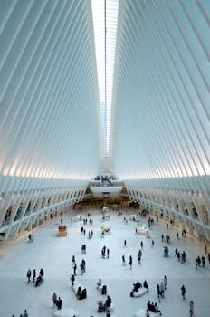 Modern architectural view of the Oculus in NYC, showcasing its futuristic design and bustling interior.