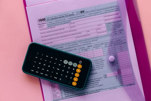 pexels-photo-6863518-6863518 Tax form 1040 with a calculator on a pink background, highlighting finance and accounting themes.