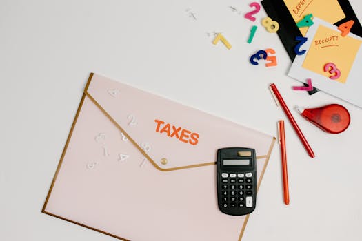 pexels-photo-7111489-7111489 Flat lay of a tax preparation workspace with calculator, envelope, and colorful numbers.