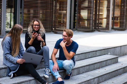 pexels-photo-1438072-1438072-1 Three young professionals having a friendly chat while sitting on outdoor steps.