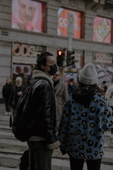 pexels-photo-15652072-15652072 A busy urban street scene with pedestrians at a zebra crossing under a red light.