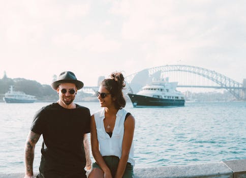 pexels-photo-1680173-1680173 A happy couple enjoying a sunny day by Sydney Harbour with the iconic bridge in the background.