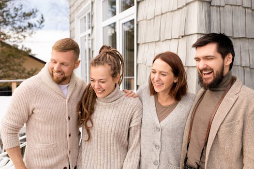 pexels-photo-3758032-3758032 Four friends laughing and bonding outdoors in a cozy winter setting.