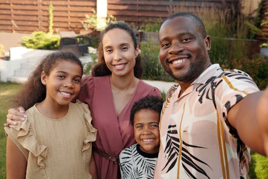 pexels-photo-5082949-5082949 Smiling multicultural family enjoying time together outdoors in their garden.