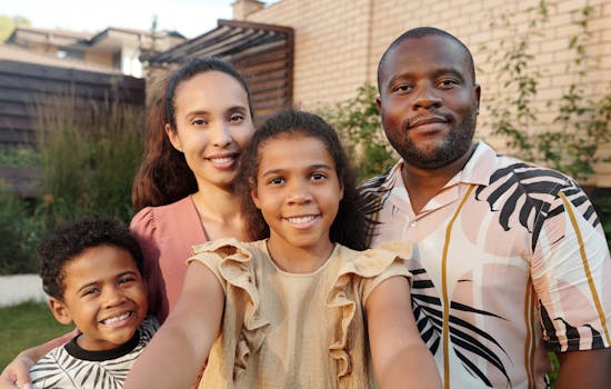 Portrait of a joyful multicultural family smiling together in the garden.