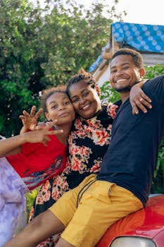Happy family posing together outdoors, exuding joy and unity on a sunny day.