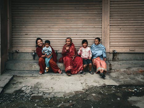 Family of different ages smiling together on an urban sidewalk.