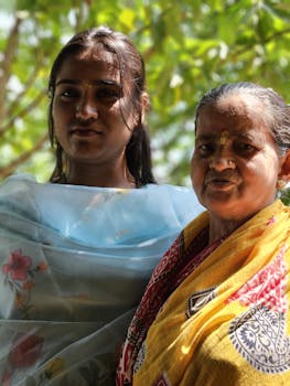 Portrait of a senior and young woman in colorful attire outdoors, captured beautifully in natural light.