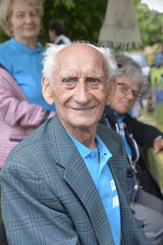 Senior adults gathered outdoors enjoying social time together on a bright day.
