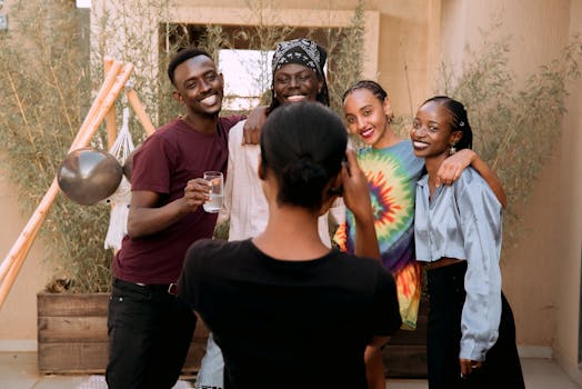 Group of friends smiling and posing for a picture outdoors, capturing joyful moments together.