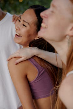 Capture of diverse group of friends laughing and bonding outside, full of joy and camaraderie.